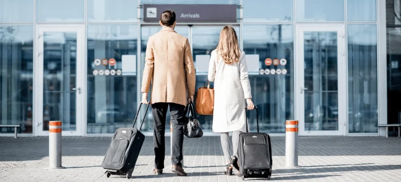 Travelers arriving at the airport with their luggage