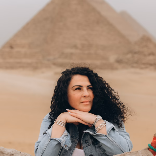 Traveler relaxing near camel saddle with Giza Pyramids in Cairo Egypt