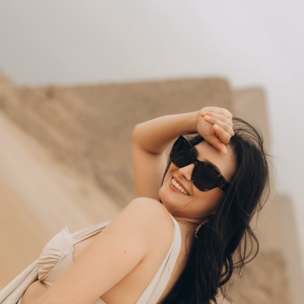 Smiling traveler at Giza Pyramids enjoying Egypt tour with Book Egypt Travel