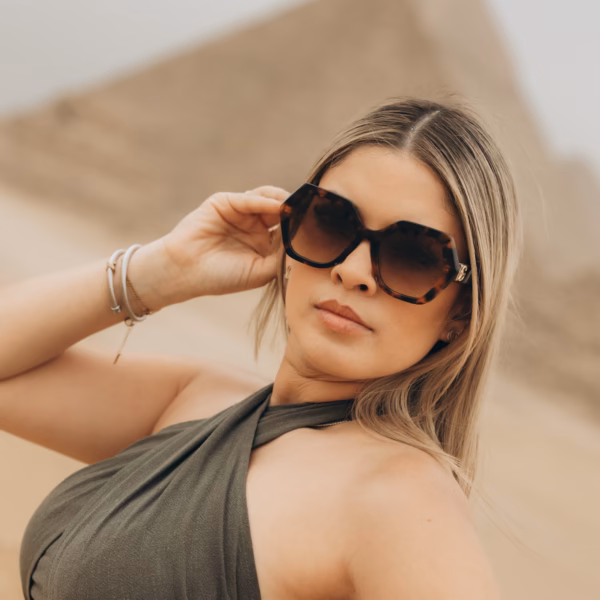 Female traveler posing near Giza Pyramids in Cairo Egypt desert
