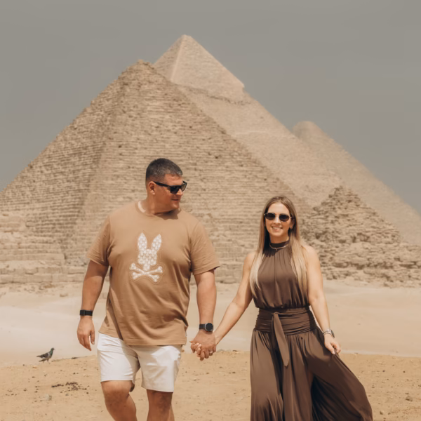 Tourists walking near the Giza Pyramids during a day trip from El Gouna by plane