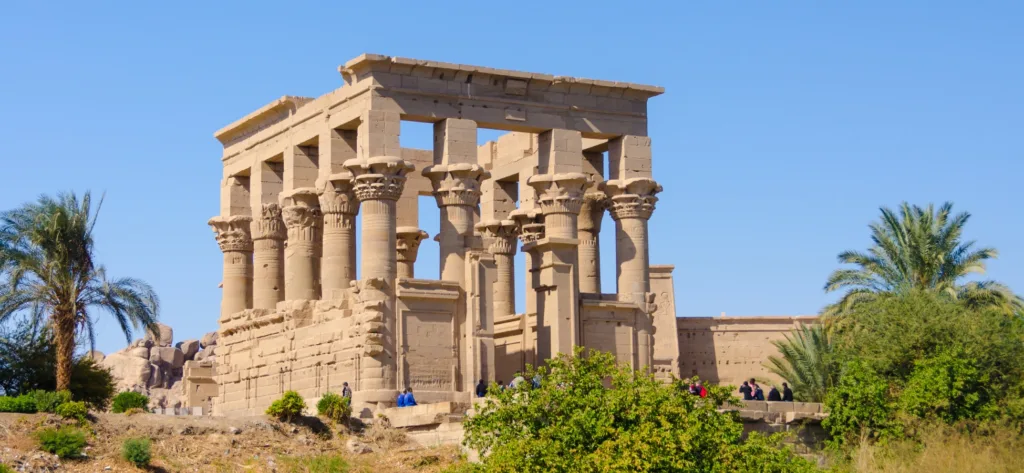Philae Temple surrounded by palm trees in Aswan