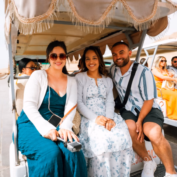 tourists riding golf cart Luxor East Bank Egypt guided tour experience