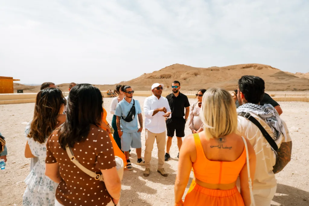 Egyptologist tour guide speaking to visitors at Hatshepsut Temple