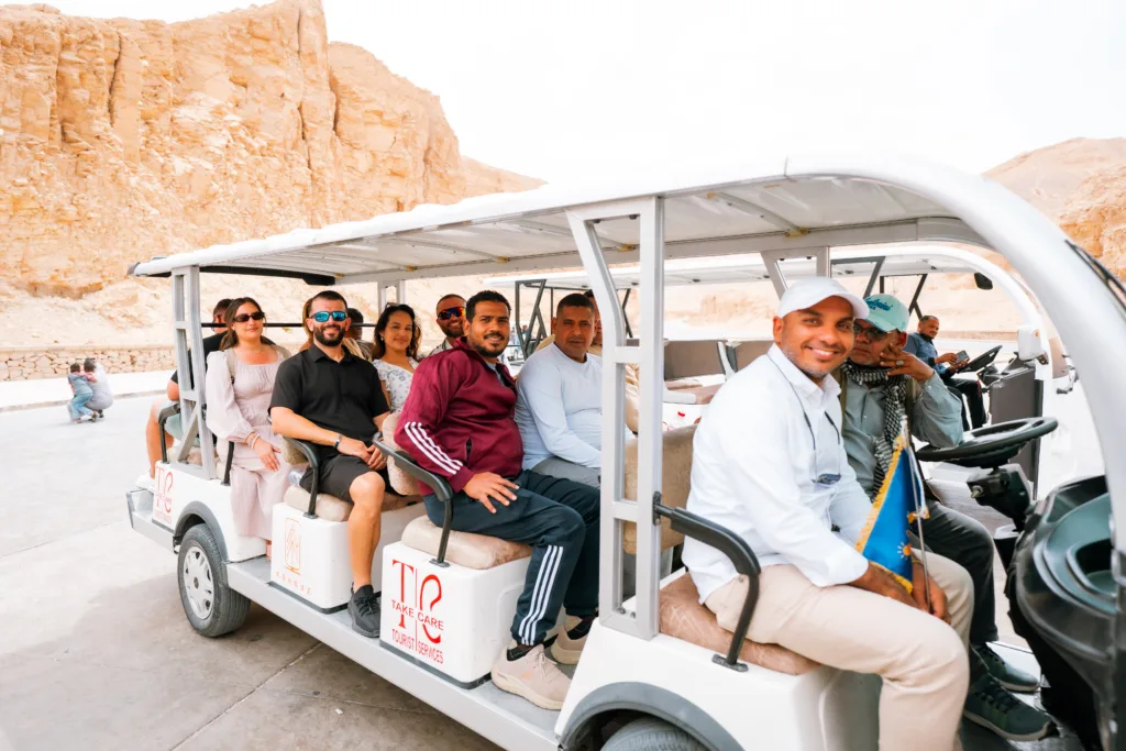 Visitors riding an electric cart at the Valley of the Kings