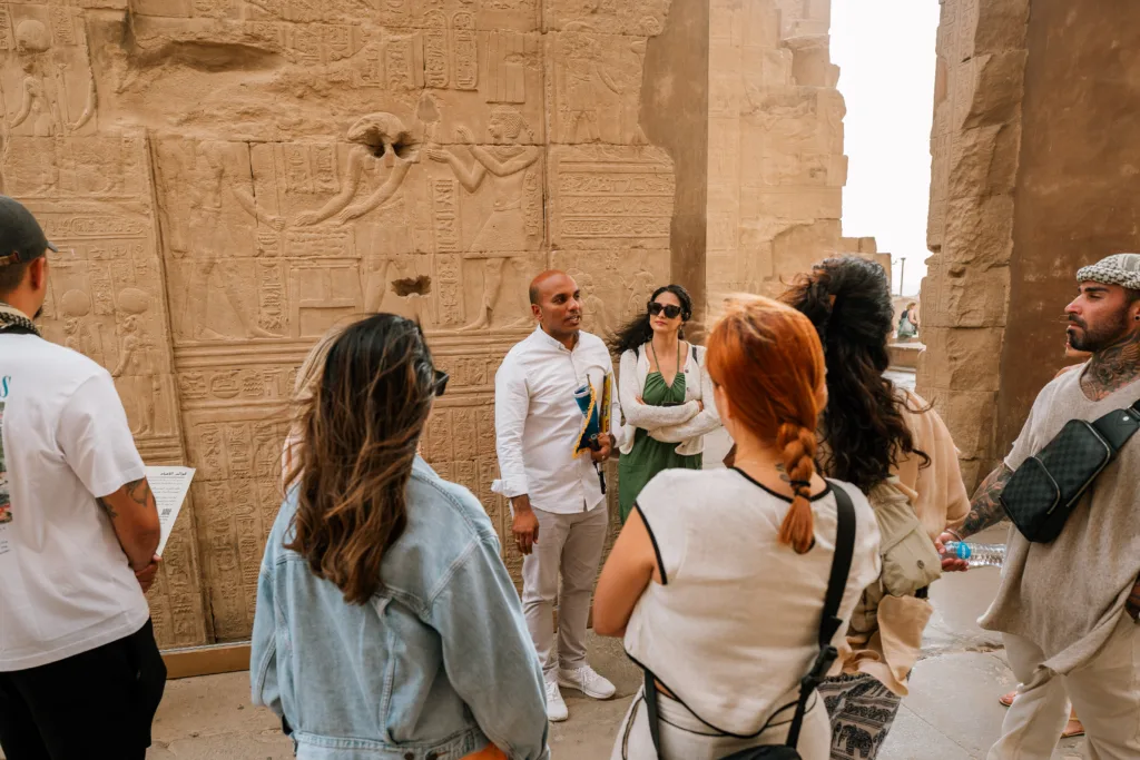 Egyptologist guide explaining ancient reliefs at Kom Ombo Temple