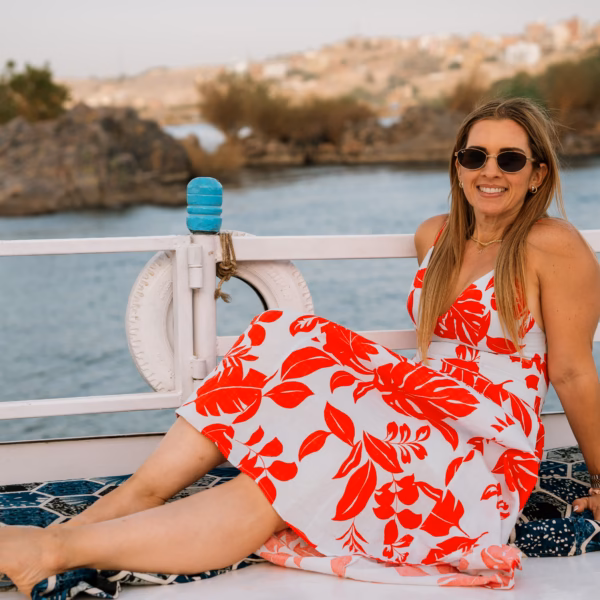 Woman relaxing on Nile River felucca in Aswan during Luxor & Abu Simbel tour from Hurghada