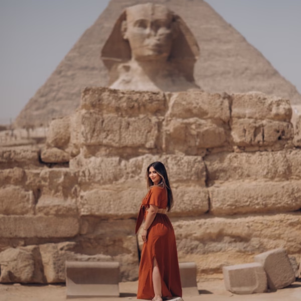Woman standing in front of the Great Sphinx and Pyramid of Giza during Egypt tour