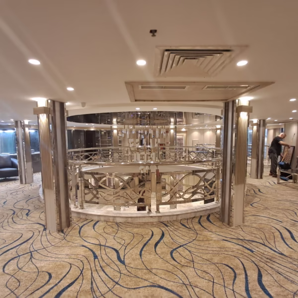 Luxury Nile cruise mezzanine lounge with wavy-patterned carpets and elegant silver railings for Egypt river travel.