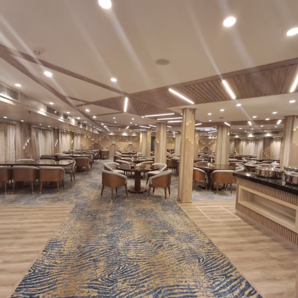 Spacious Nile cruise restaurant with modern decor, wood accents, and buffet area for a luxury Egypt travel experience.