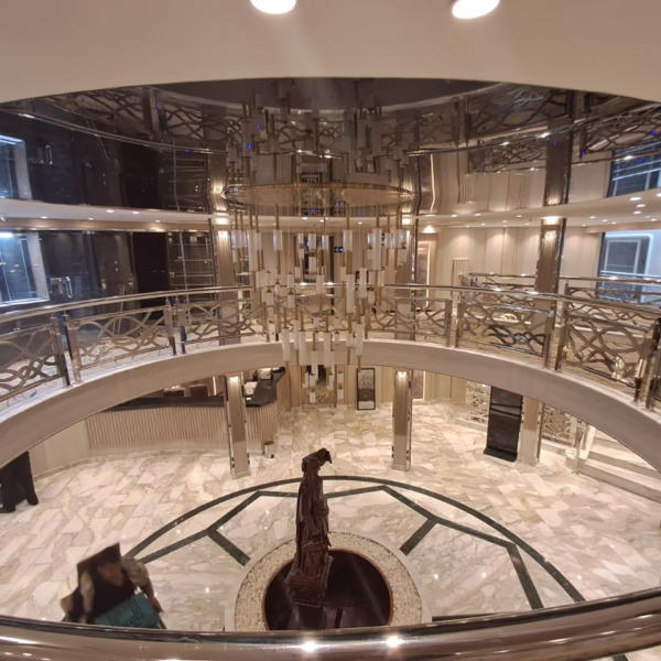 Grand marble atrium of a luxury Nile cruise ship with a gold chandelier and central statue for an Egypt river tour.