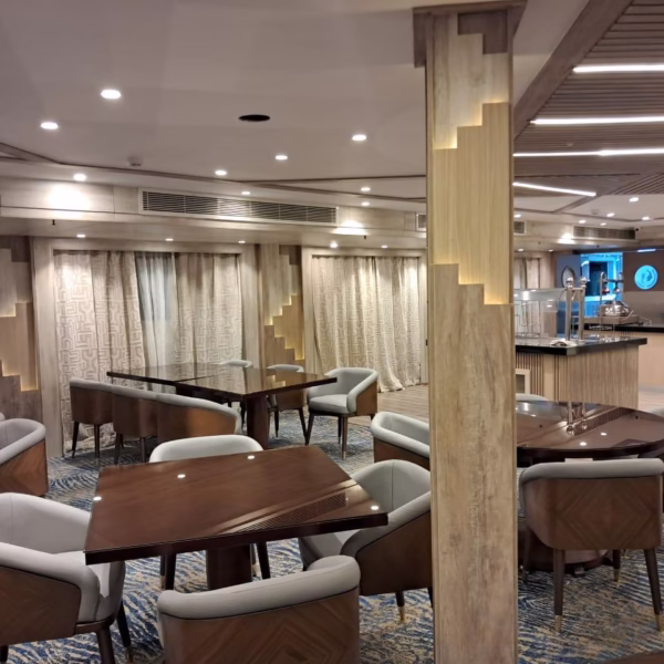 Upscale Nile cruise dining room with sleek wooden tables and modern decor, perfect for luxury Egypt travel dining.