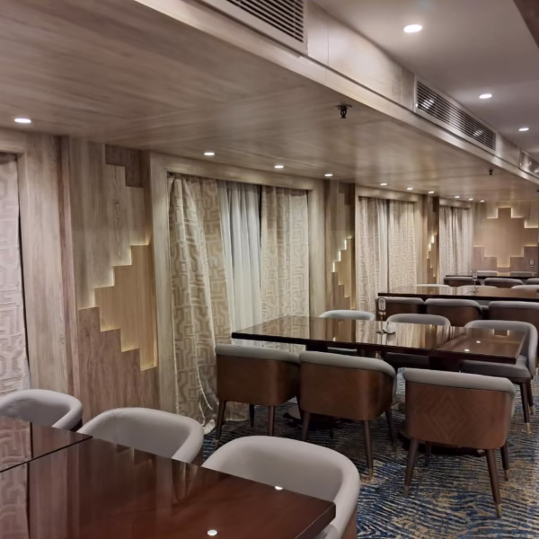 Sophisticated Nile cruise dining room with elegant wood paneling and plush seating for a luxury Egypt river tour.