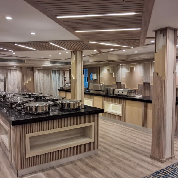 Modern Nile cruise buffet area featuring silver chafing dishes and elegant wood finishes for luxury Egyptian dining.