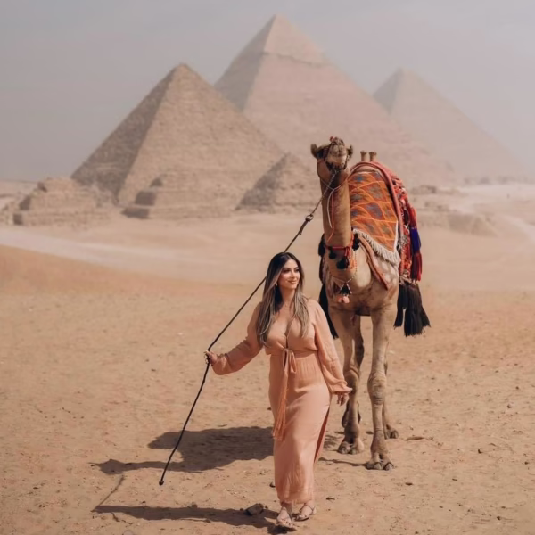 Girl holding camel in Giza Pyramids