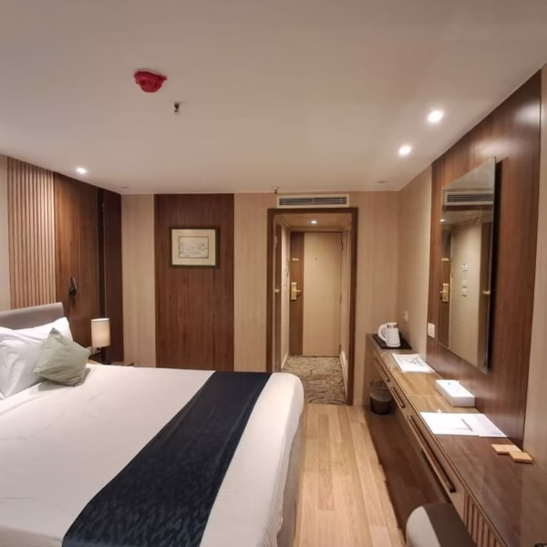 Modern double cabin on a Nile cruise with wood-paneling, blue accents, and vanity for luxury Egypt river travel.