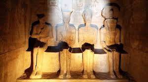 The four seated statues in the inner sanctuary of Abu Simbel Temple illuminated by direct sunlight.