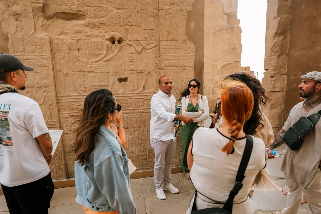 Egyptologist guide explaining ancient reliefs at Kom Ombo Temple