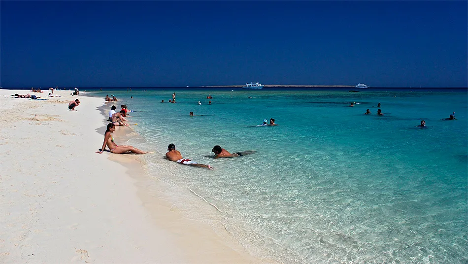 Tourists swimming in crystal-clear water at Giftun Island, Hurghada
